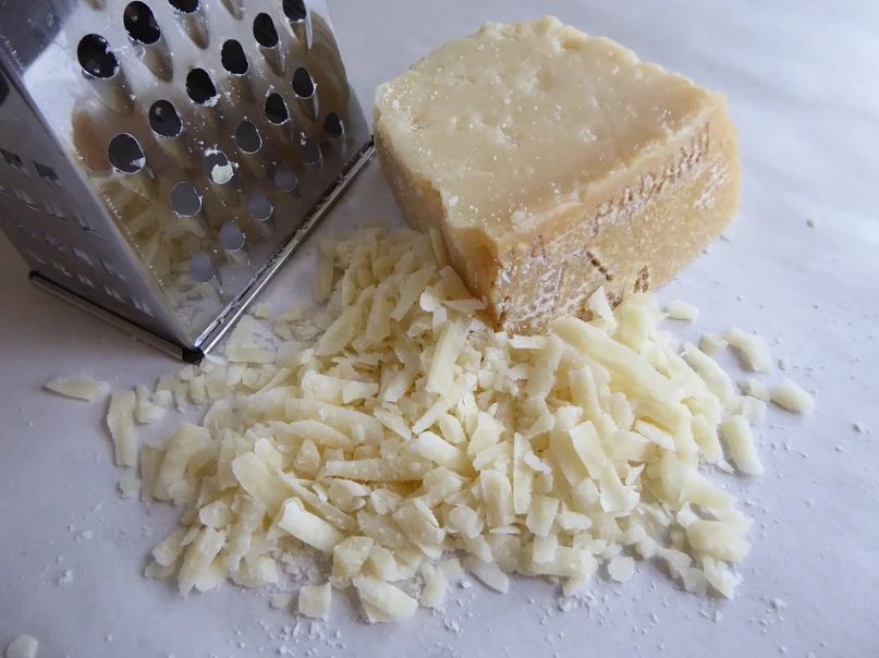 Image of grated parmesan cheese on a shelf.