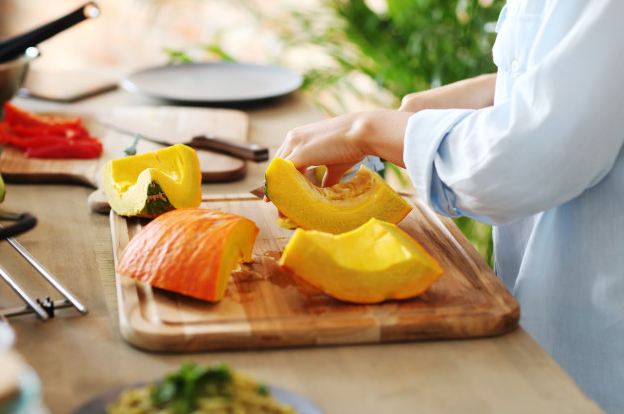 a woman chef cutting pumpkins