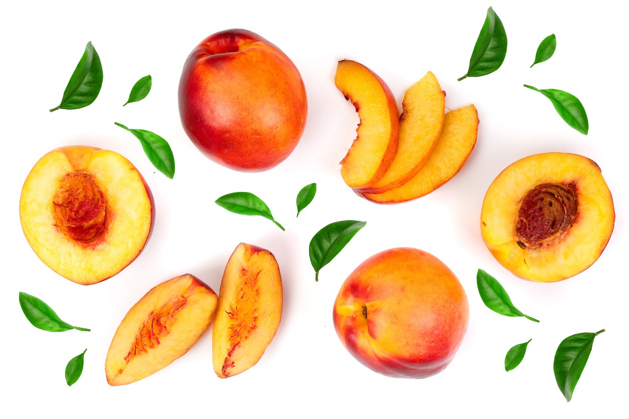 ripe nectarine with leaves isolated on white background. Top view. Flat lay pattern