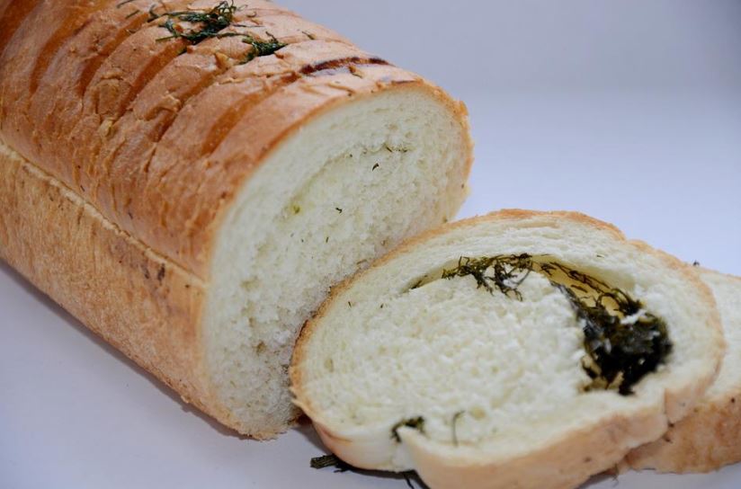 dill wheat bread with two loaf slices