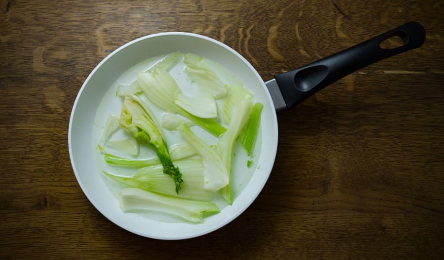 fennel herbs in a white frying pan
