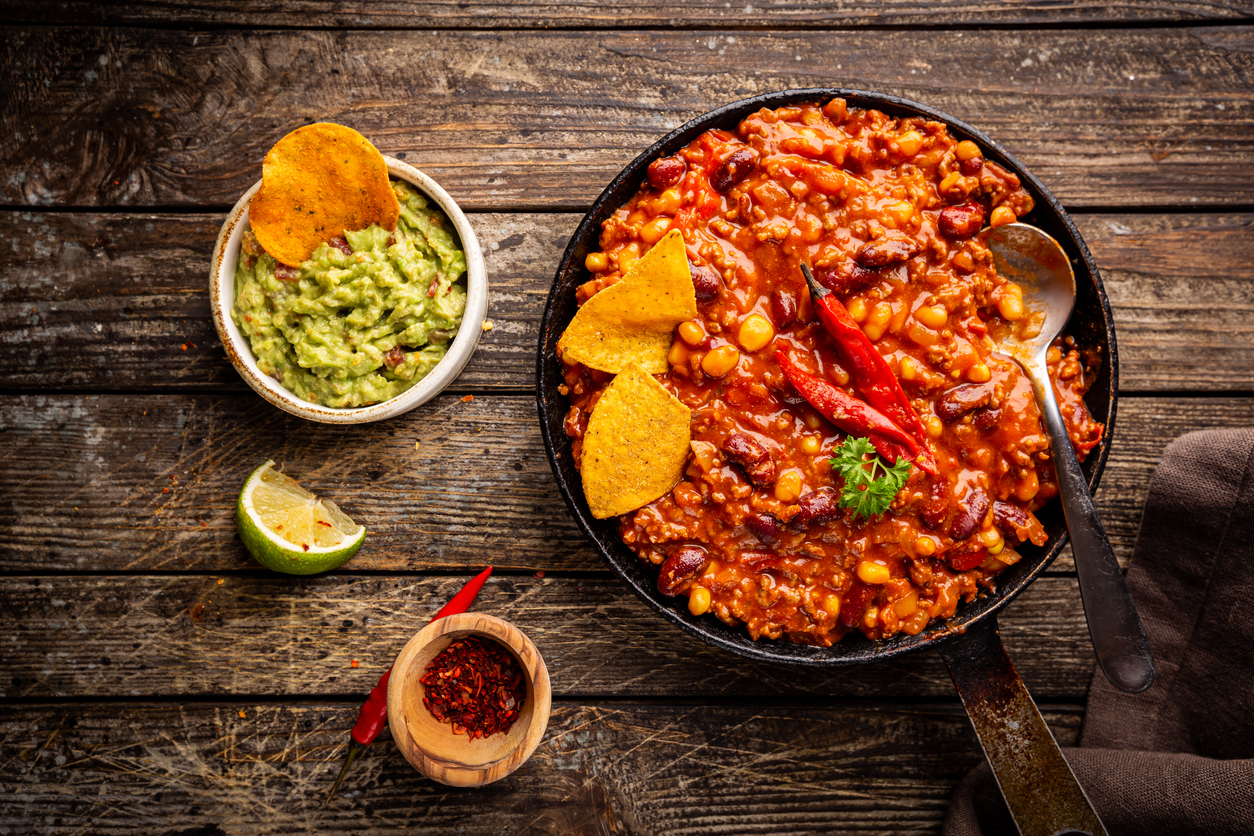 hot chili con carne in a pan with tortilla chips