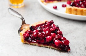 Tart, pie, cake with jellied fresh cranberries, bilberries