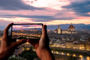 Tourist taking photo of Florence at sunset from Piazzale Michelangelo, Florence, Italy