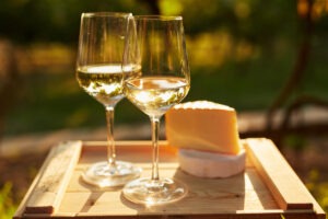 Two glasses of white wine with cheese