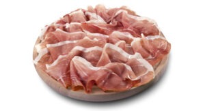 Round chopping board with sliced Parma ham