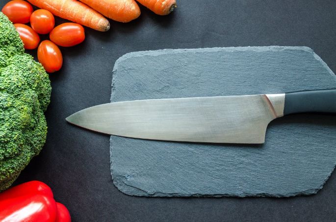Sharp kitchen knife on a cutting board