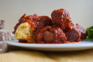 Close up of a sausages with tomato sauce and polenta