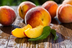 Fresh peaches, Peach close up fruit background, peach on wood background,sweet peaches, group of peaches,sliced peaches, peach slices