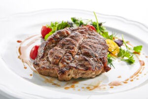 Pork Neck Steak with Mixed Salad on White Restaurent Plate