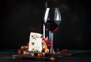 Port wine and blue cheese, still life in rustic style, vintage wooden table