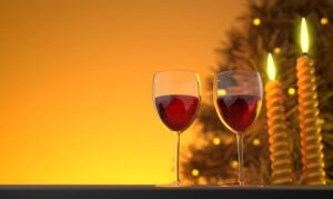two glasses of wine, candles, table, tree