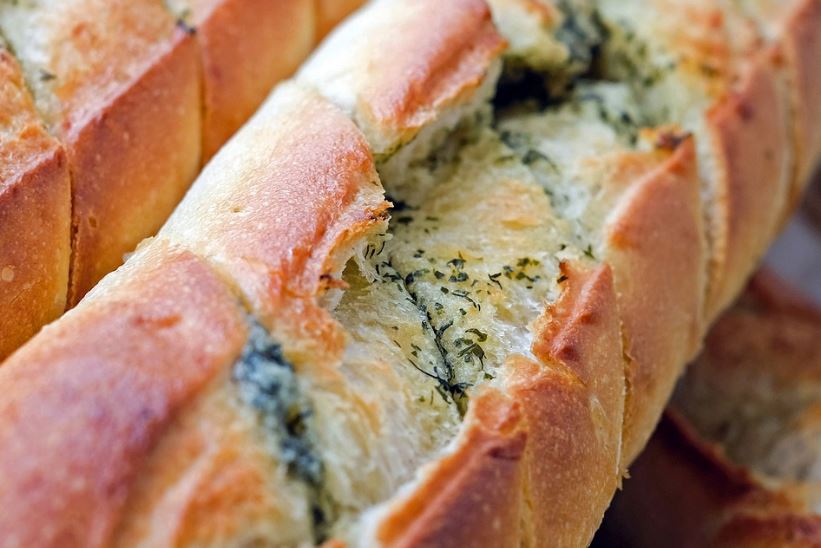 a close up of an herb and cheese bread